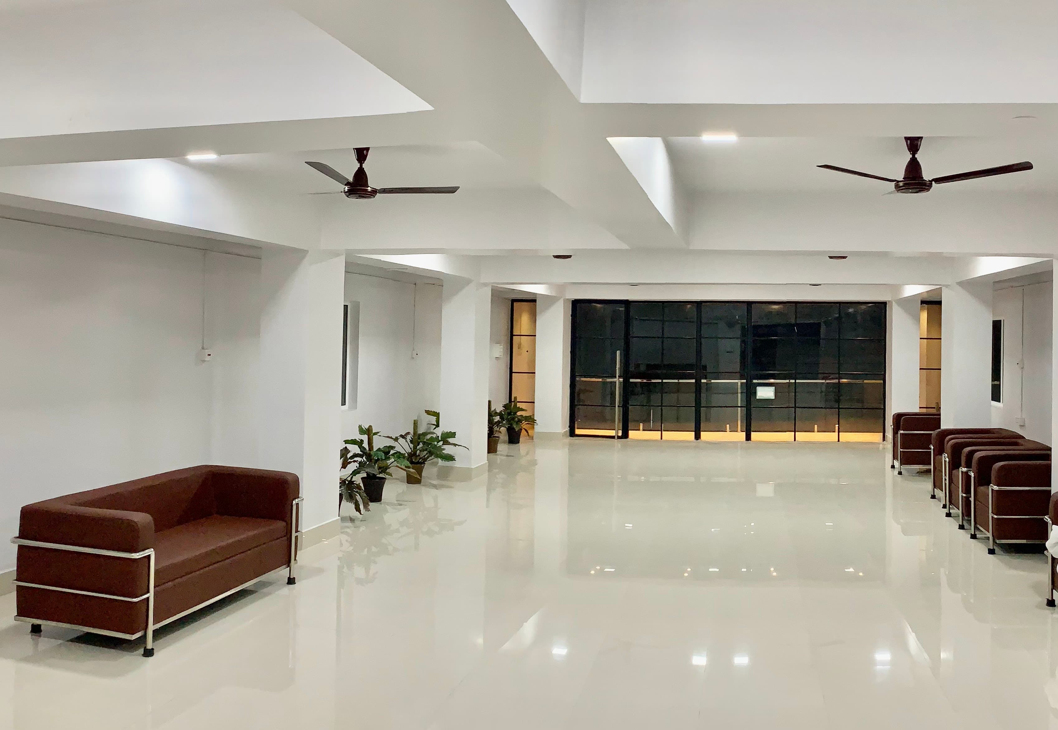 Bright banquet hall at Shanti Regency with open floor space and seating